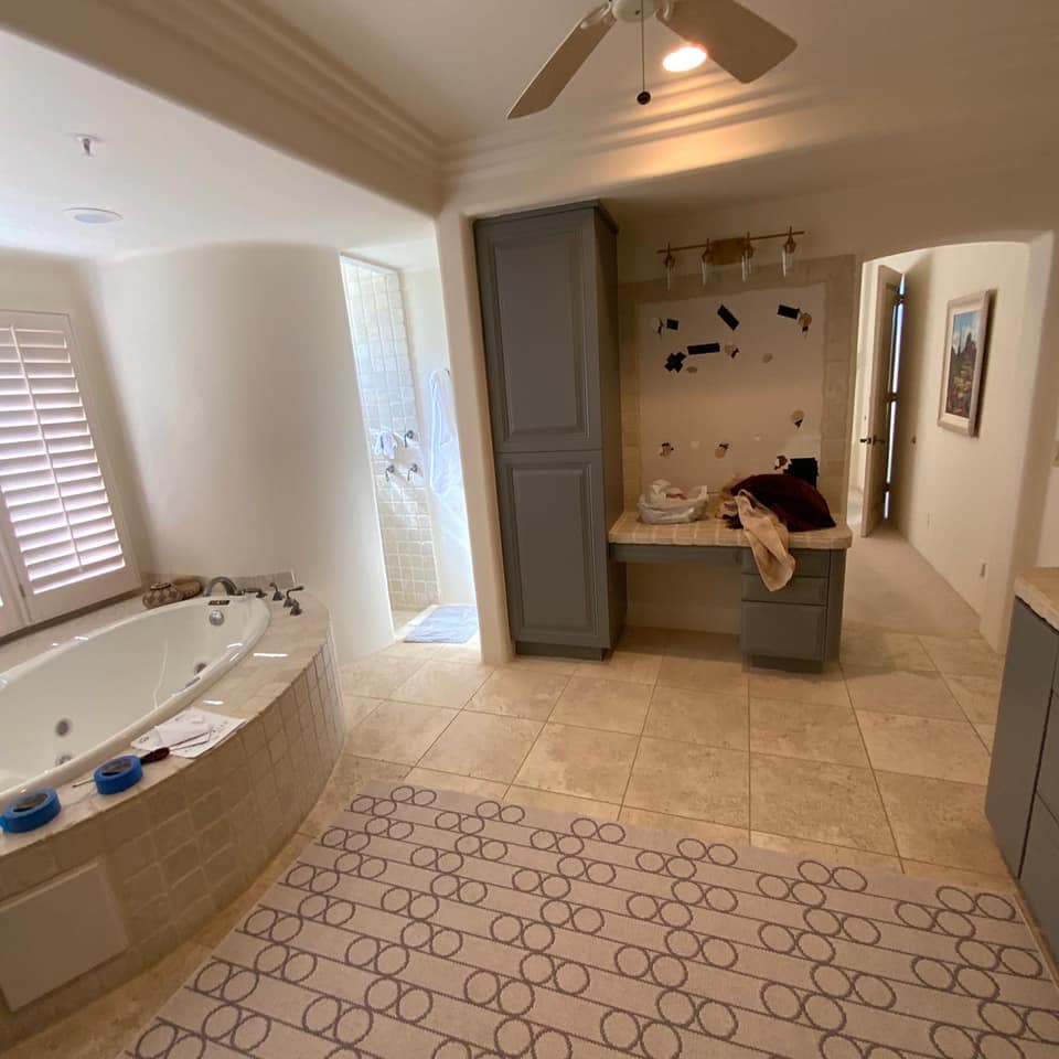 A bathroom with a jacuzzi tub and a ceiling fan