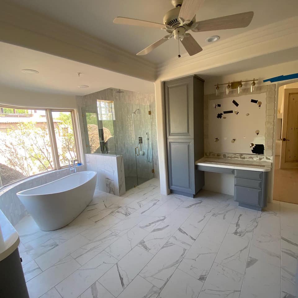 A bathroom with a bathtub and a ceiling fan