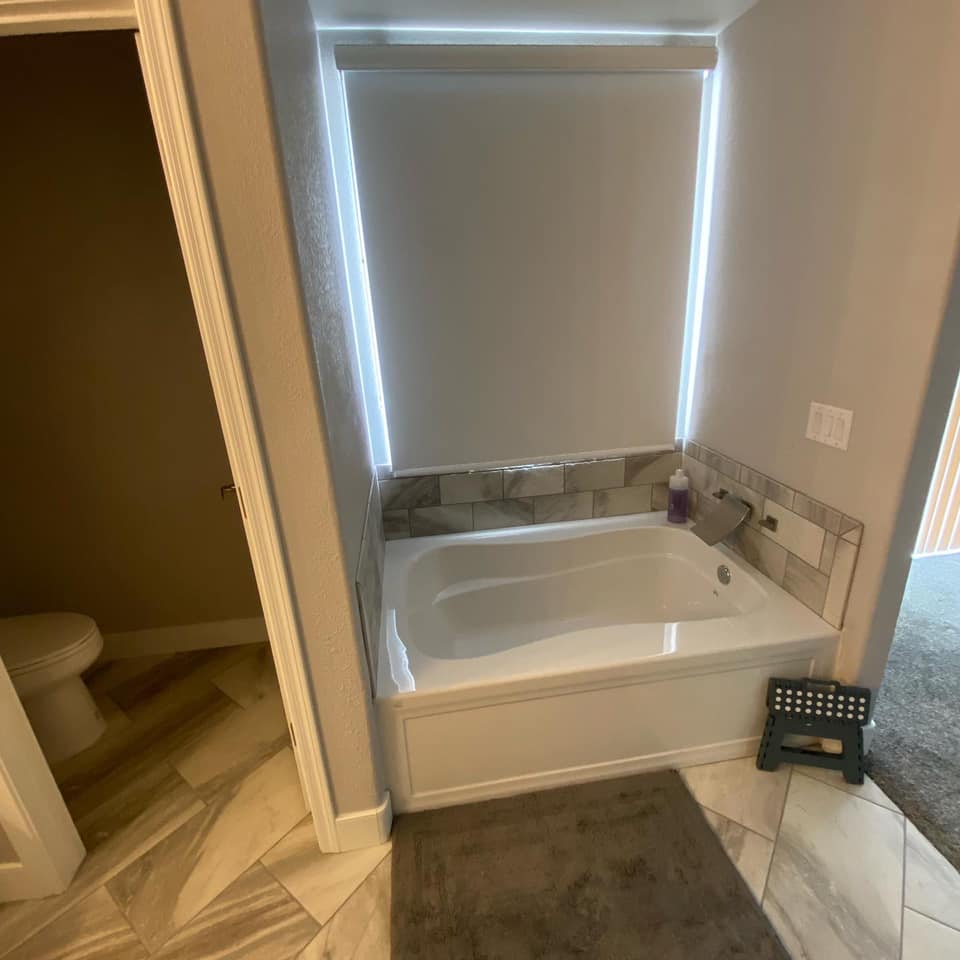 A bathroom with a bathtub and a toilet.