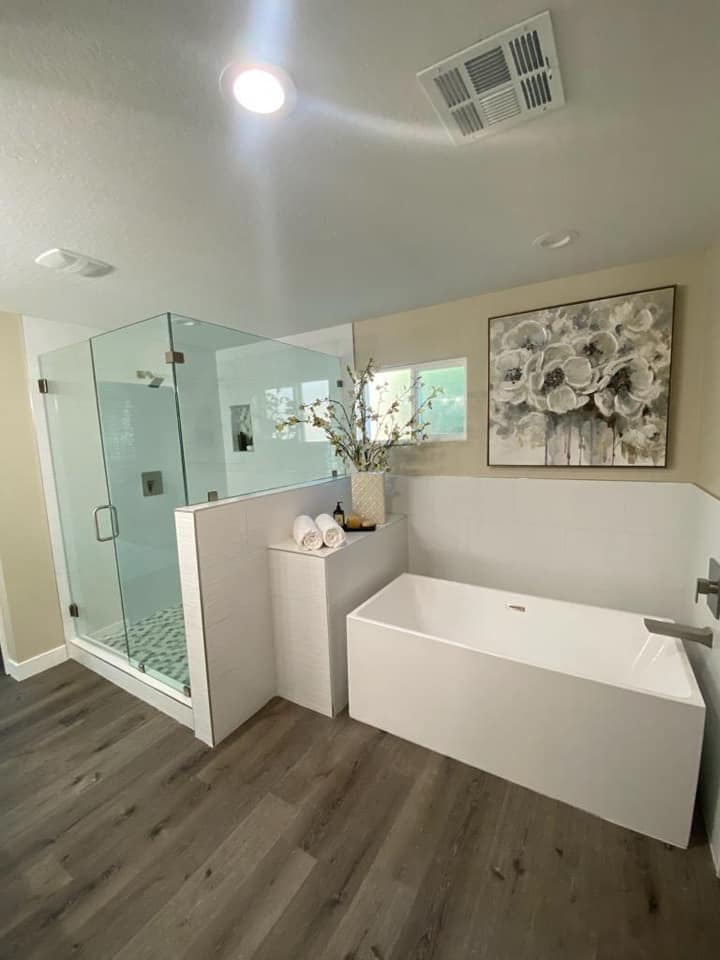 A bathroom with a bathtub and a walk in shower.