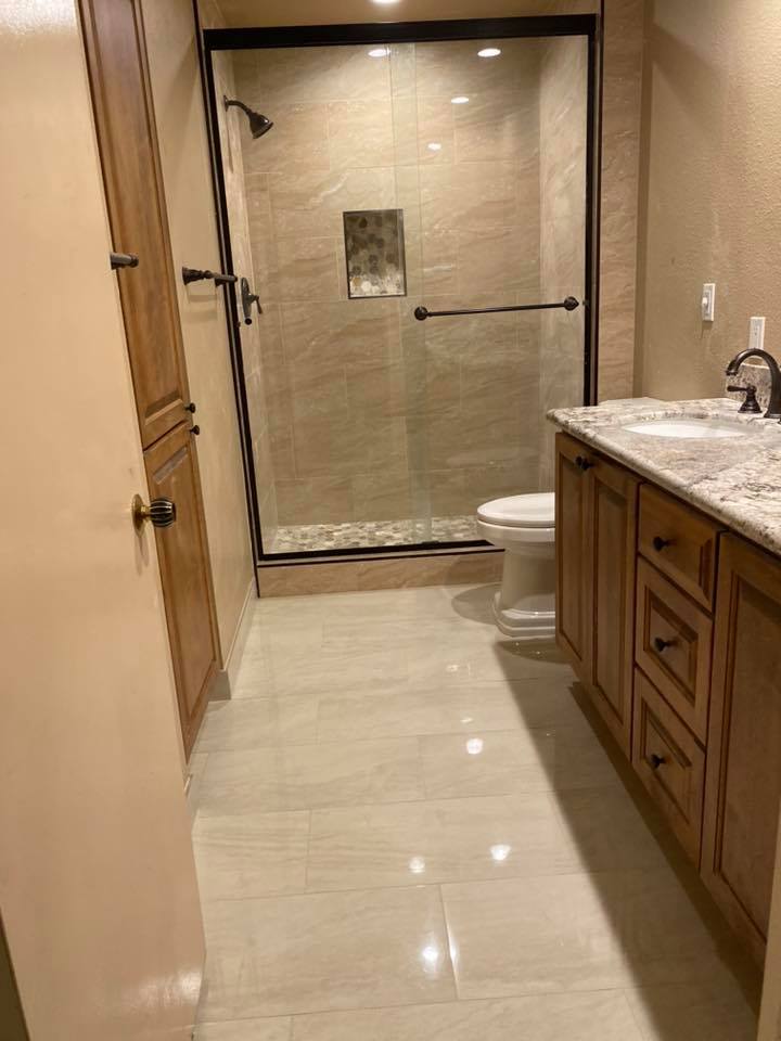 A bathroom with a toilet , sink , and shower.