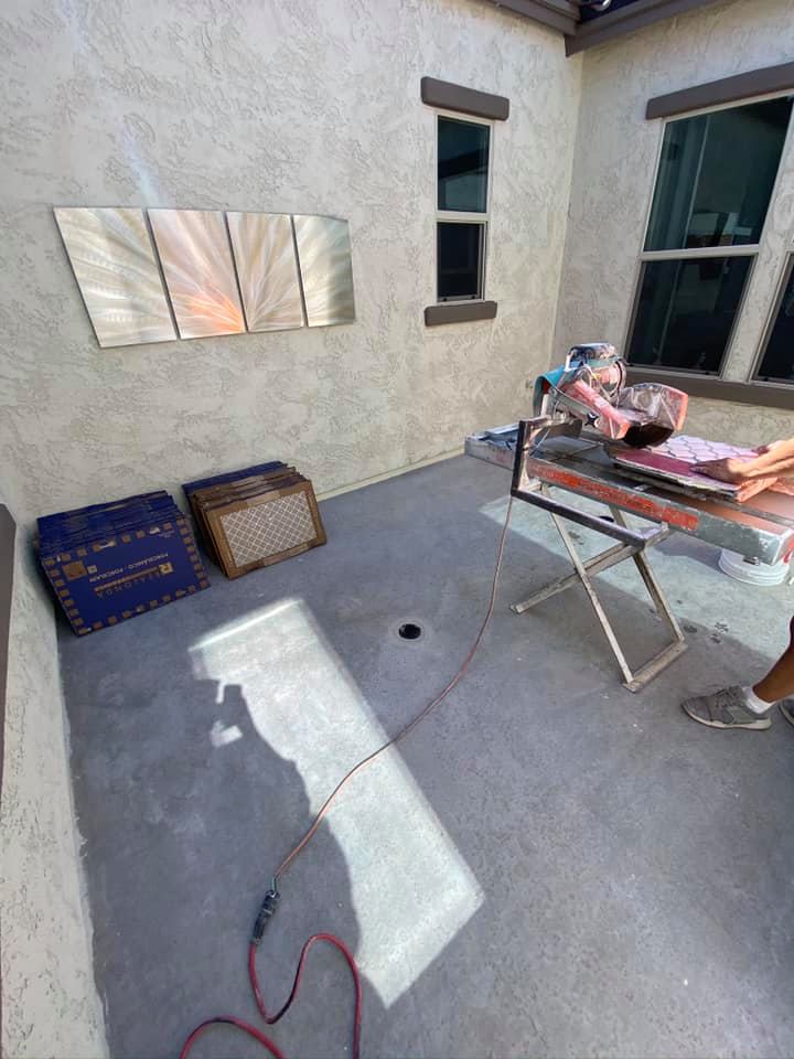 A person is standing in a room with a table and a mirror on the wall.