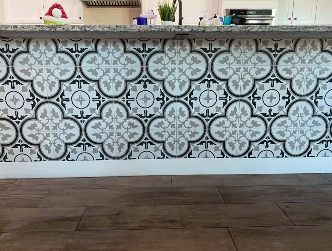A kitchen counter with a black and white tile pattern on it.