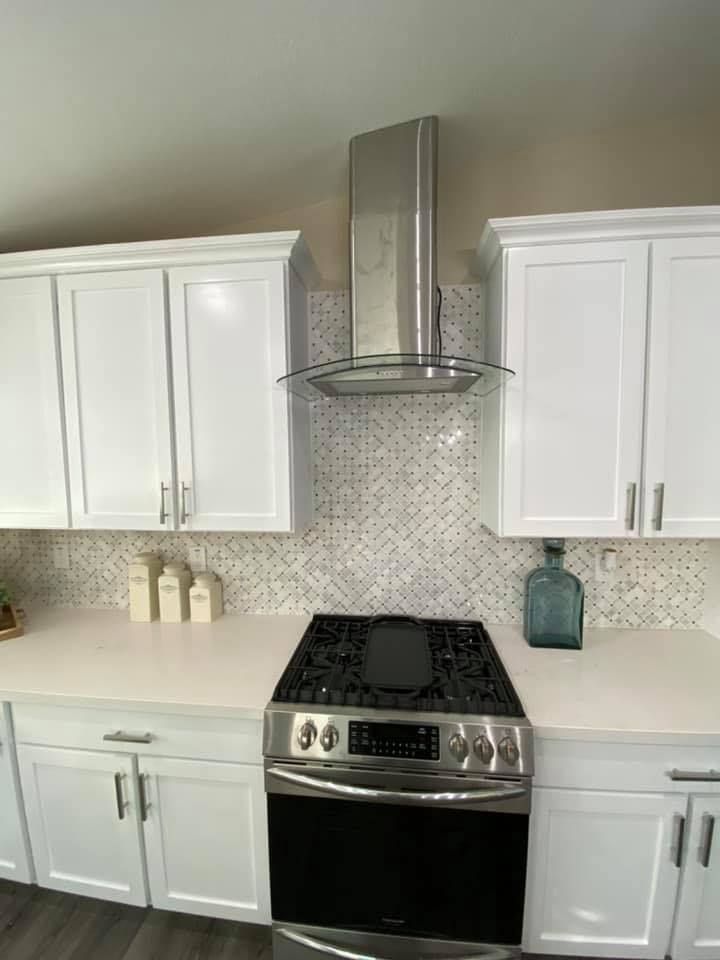 A shower niche in a bathroom with white tiles and a shelf.