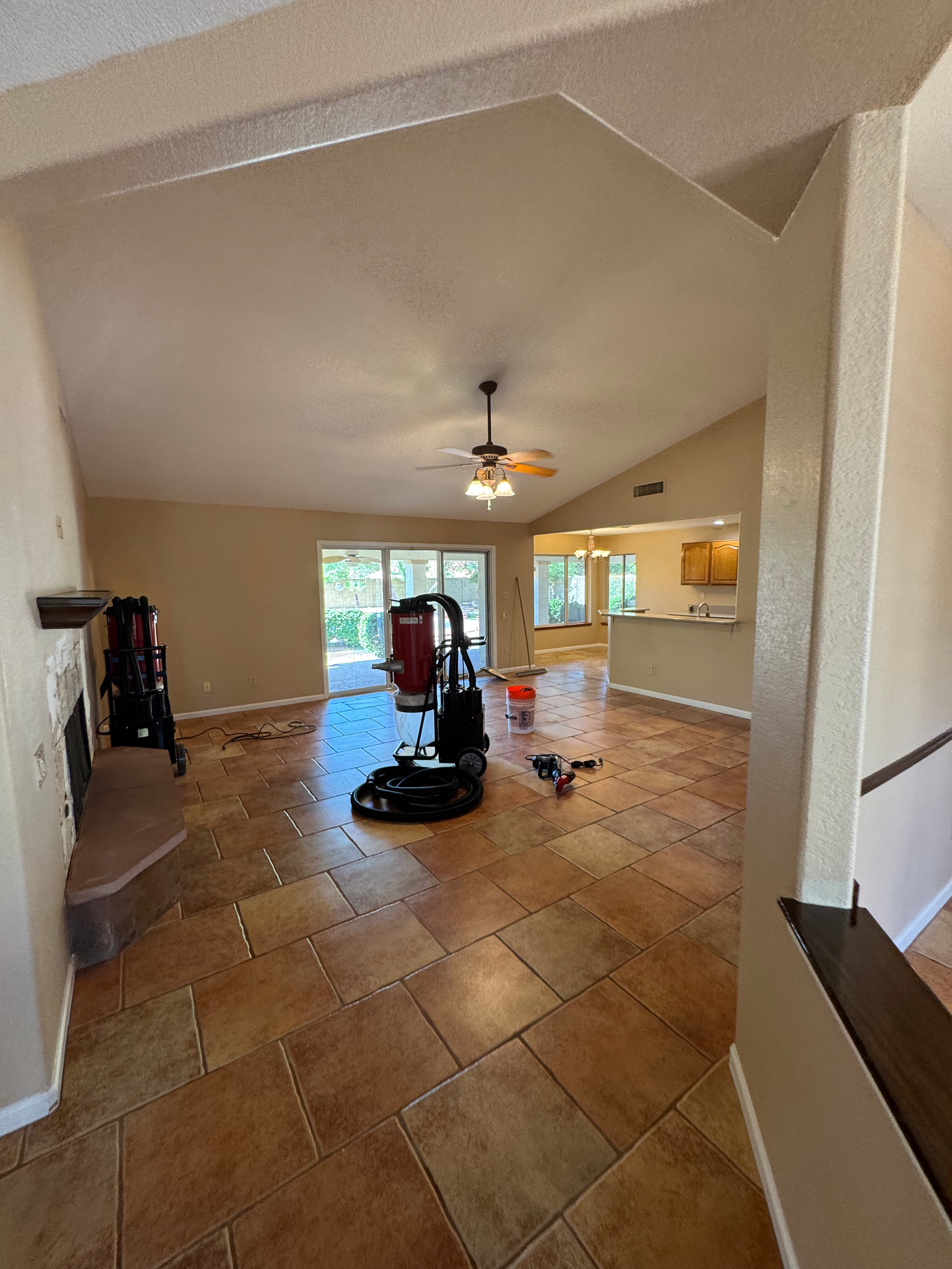 A living room with tile floors and a ceiling fan.