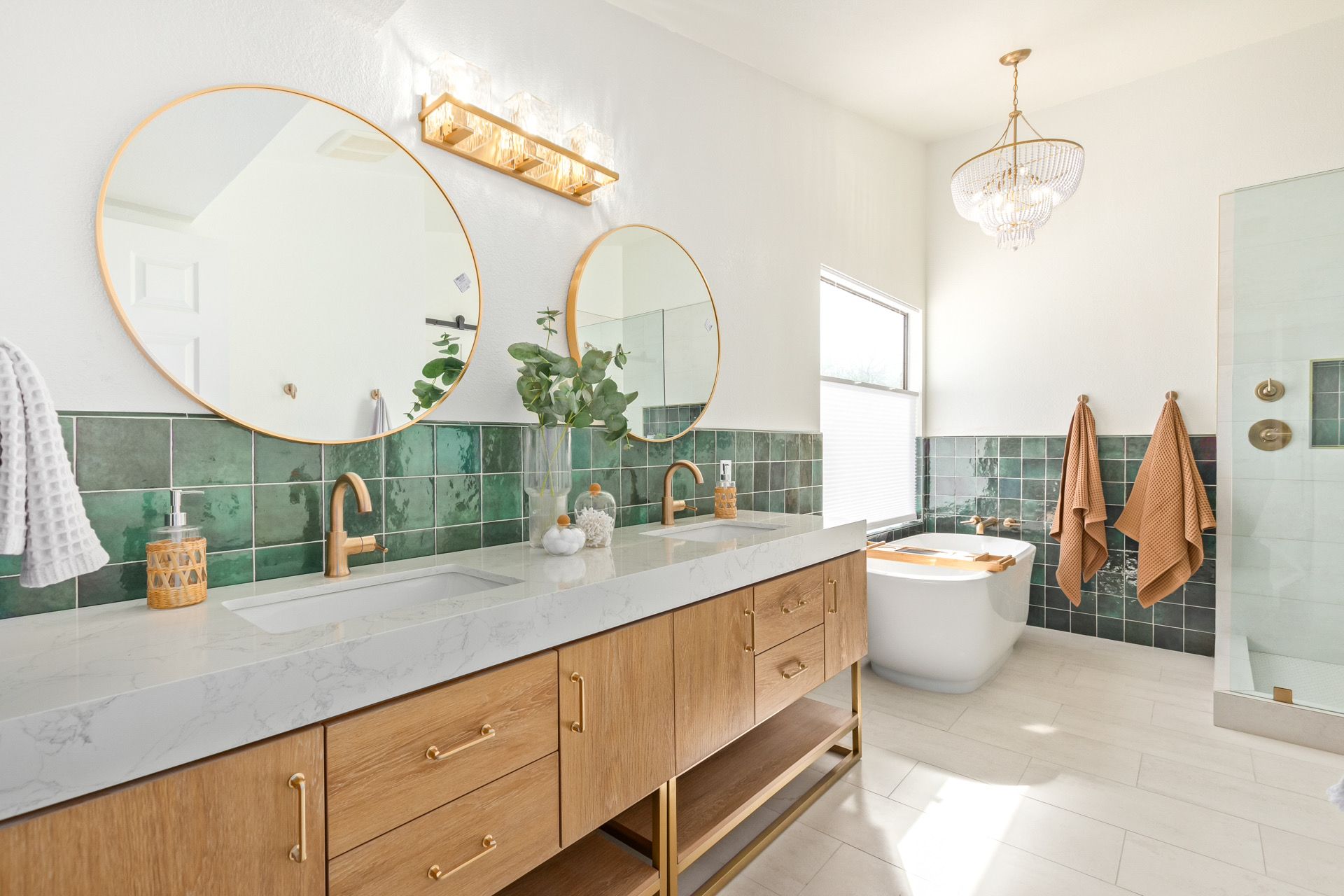 A bathroom with two sinks , two mirrors and a bathtub.