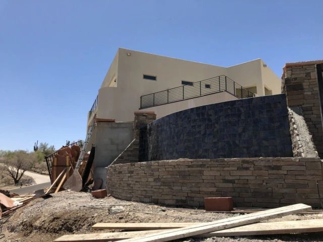 A shower niche in a bathroom with white tiles and a shelf.