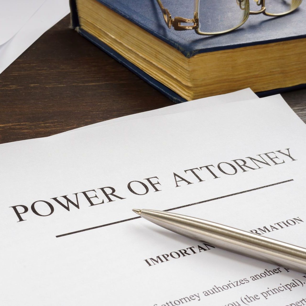 A pen sits on top of a power of attorney
