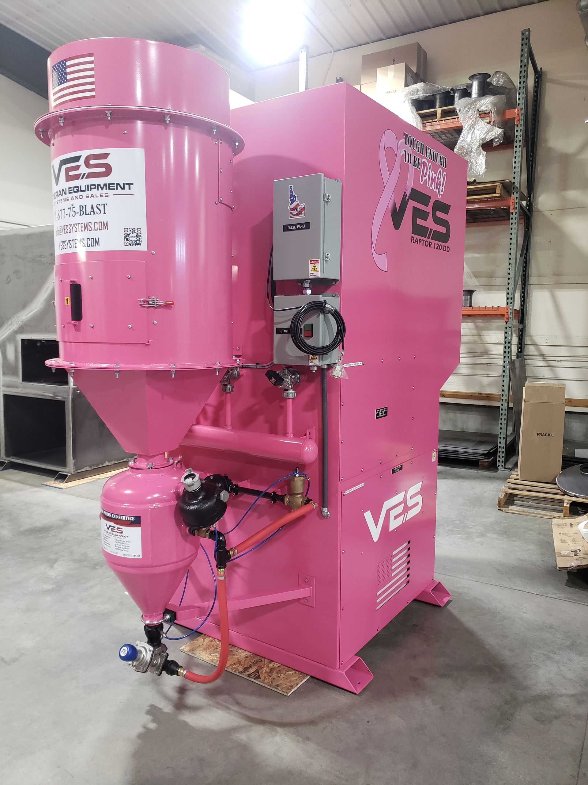 Pink industrial machine with the American flag and a breast cancer ribbon logo.