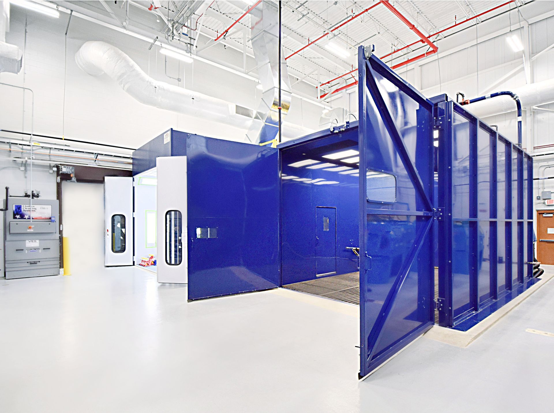 Blue sandblasting cabinet with a worker's station; a tool used for cleaning surfaces by abrasion with sand.