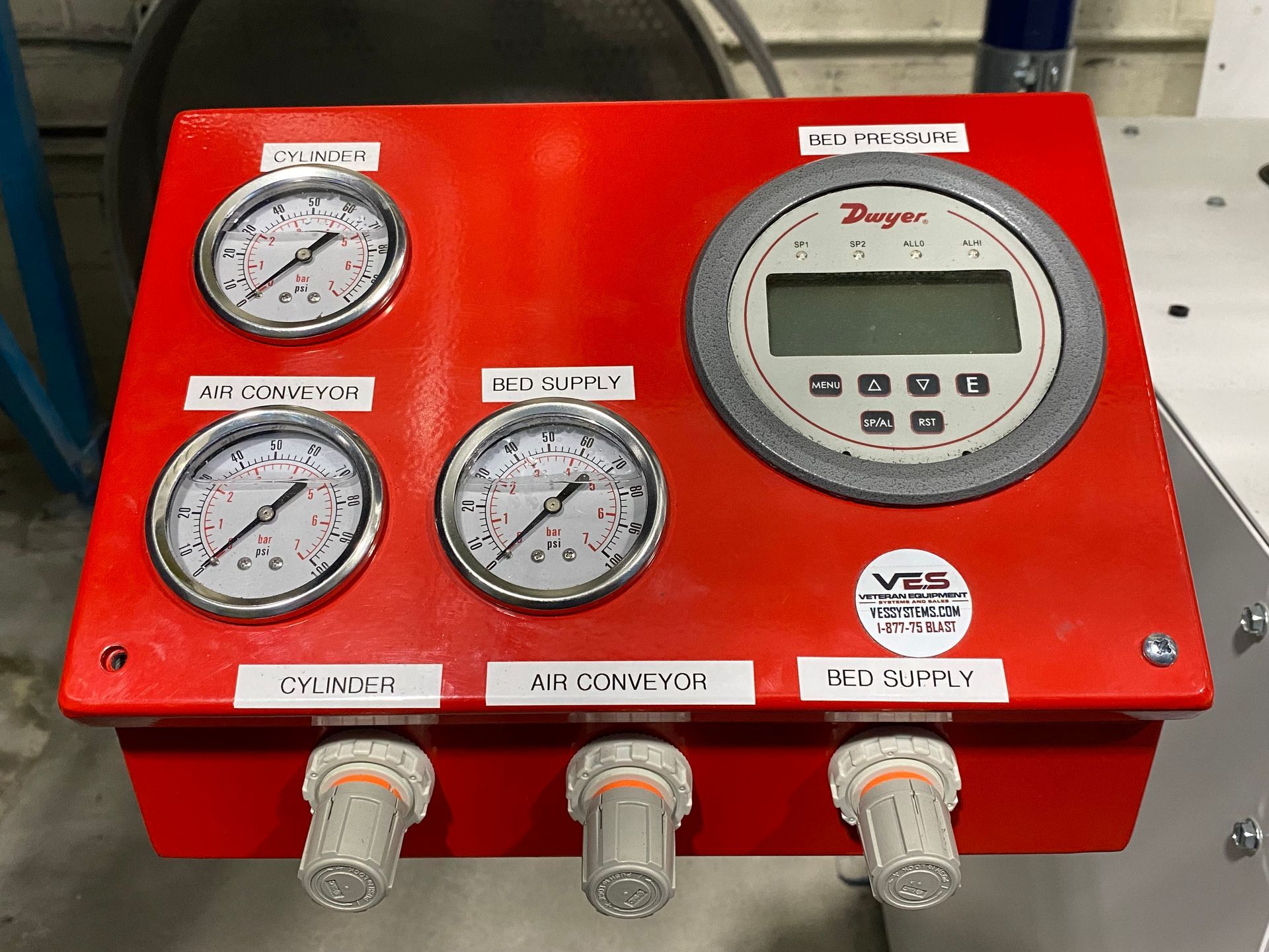 Red control panel with gauges and digital display, labeled