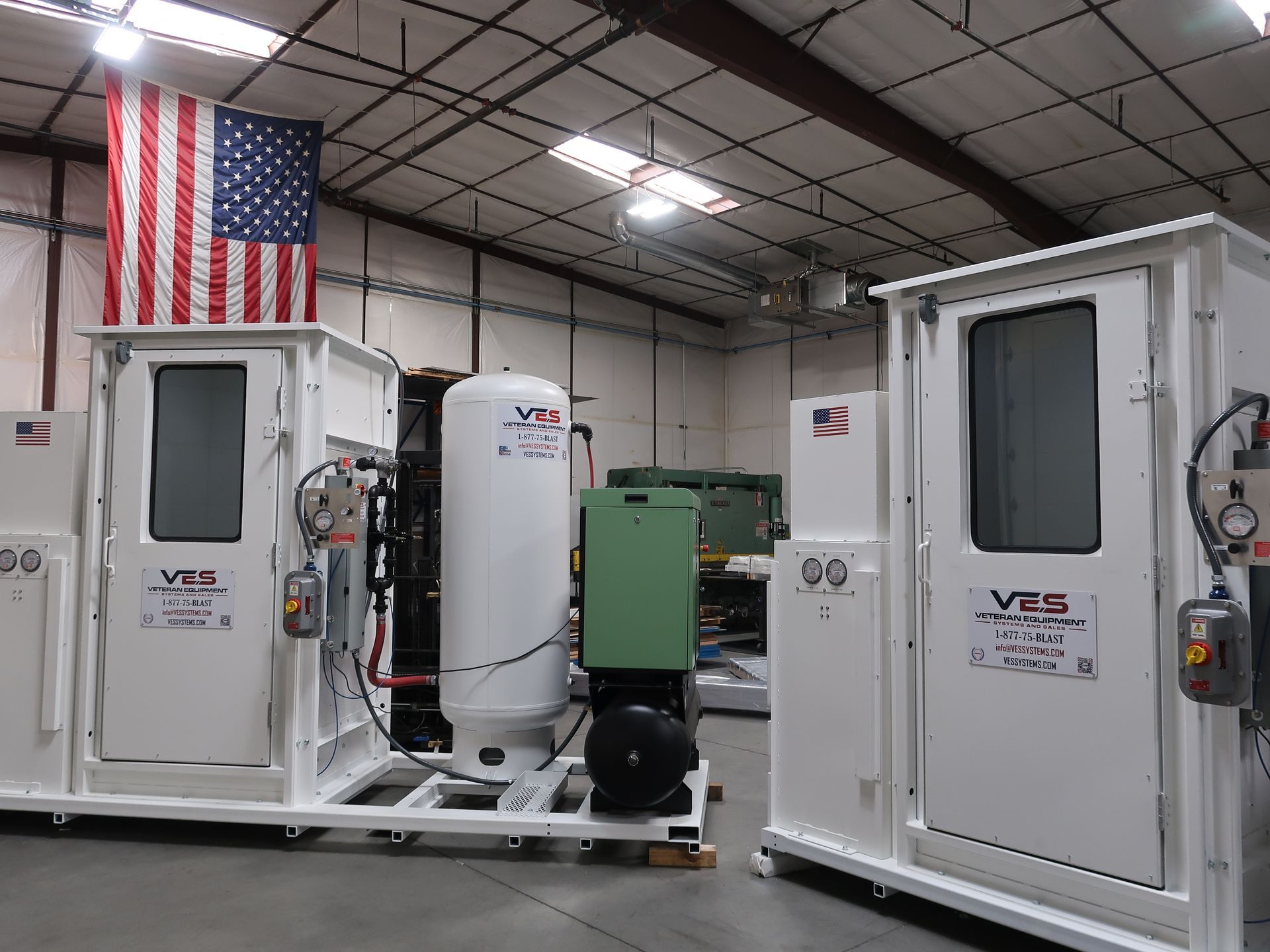 Two white industrial units with the American flag inside a factory.