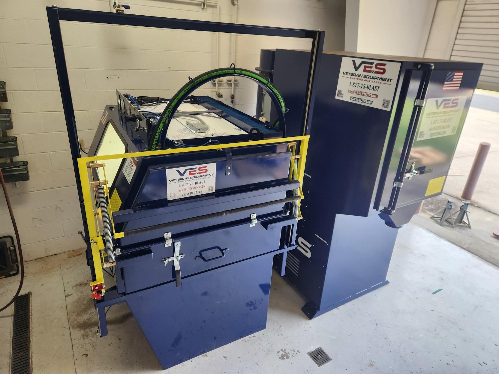 Blue industrial machine with yellow safety bars. 