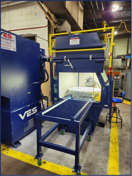 VES Raptor blast cabinet dust collector with yellow access platform and overhead ductwork.