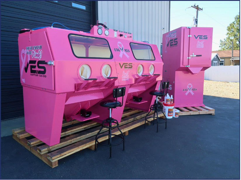 Pink VES Raptor blast cabinet and dust collector staged outside with breast cancer awareness graphics.