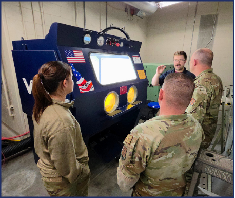 VES team member demonstrating a Raptor blast cabinet to military personnel during equipment training.