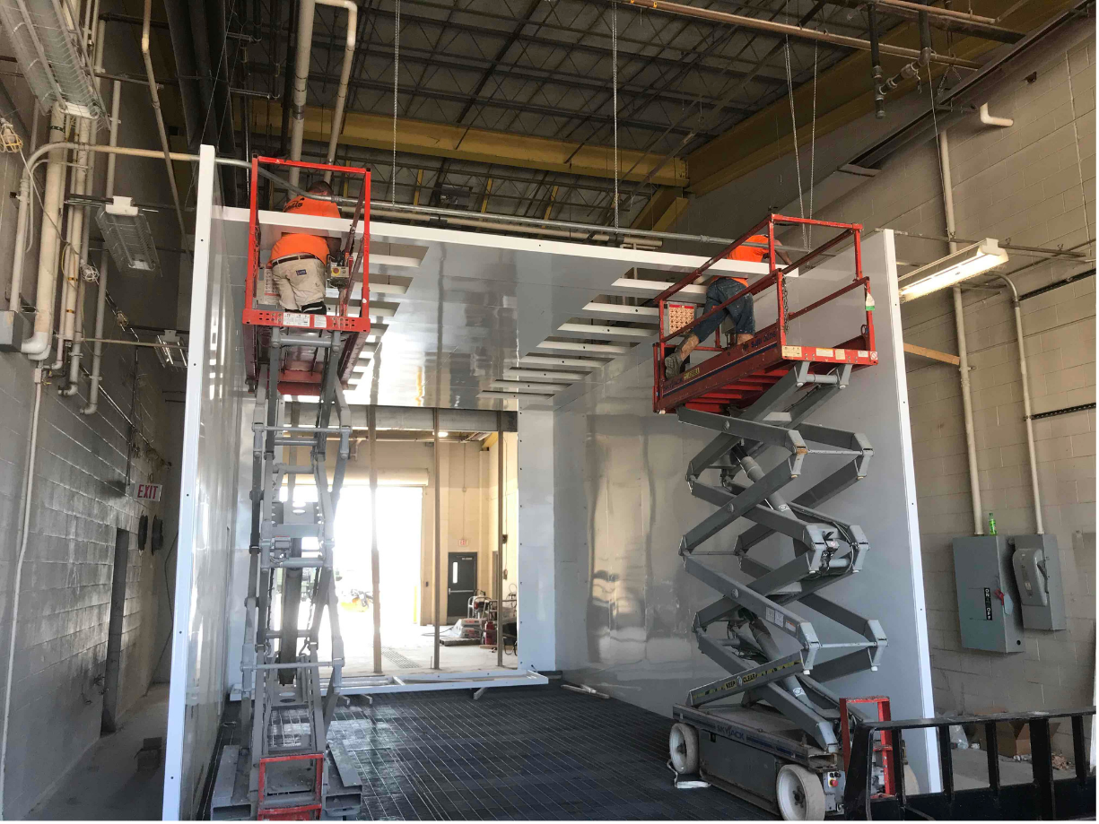 Aircraft corrosion control facility under construction with paint booth installation equipment