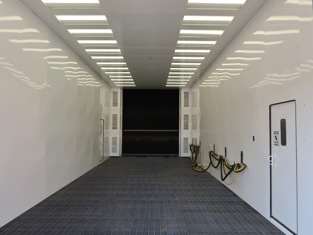 White blast booth interior with LED lighting.