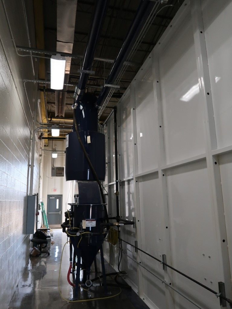 Blast booth overhead ventilation duct.