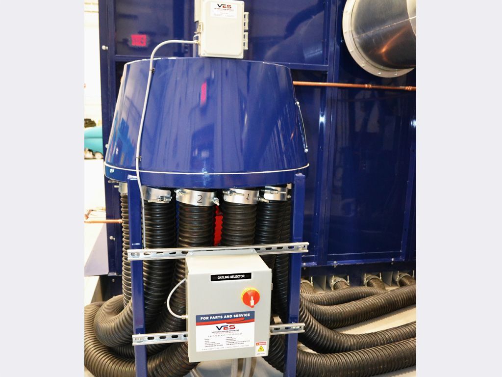 Blue industrial air filtration system with multiple hoses and a control box.