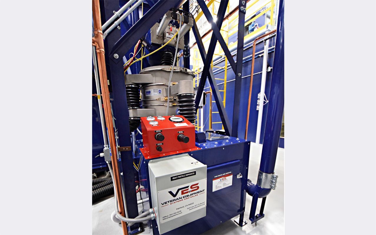 Industrial equipment with blue and red components inside a facility.