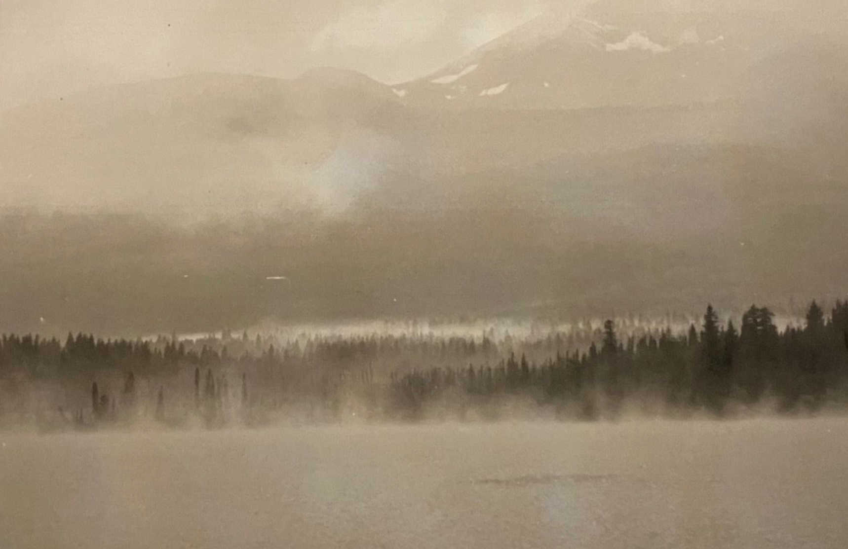 Photography print of a rocky cliff with blurred waterfall against a light background.