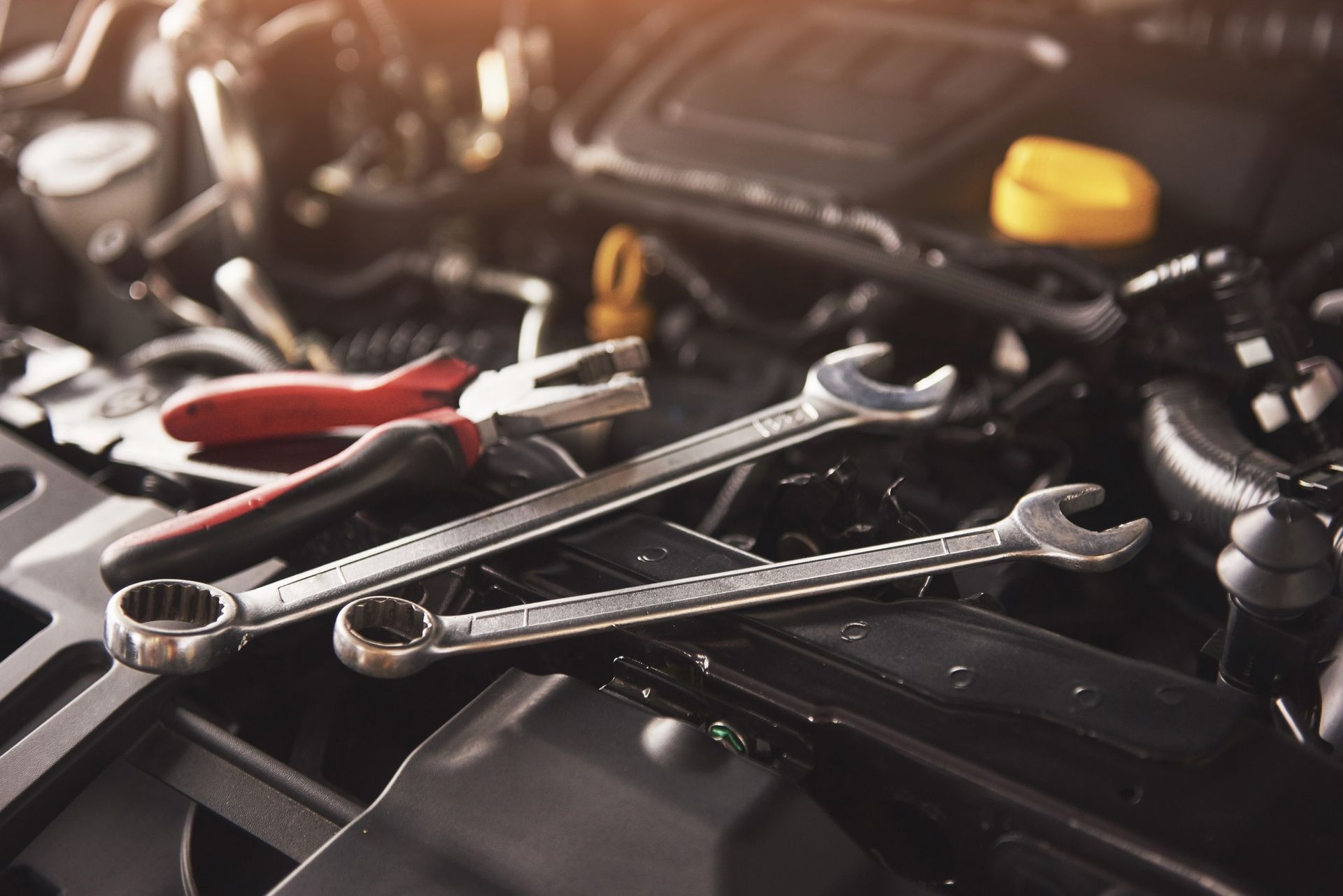 A Pair Of Wrenches And Pliers Are Sitting On The Hood Of A Car — Mareeba Motors In Mareeba, QLD