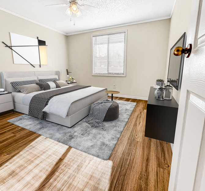 Bedroom with a bed, TV, window, and decorative art. Hardwood floors and a gray area rug.