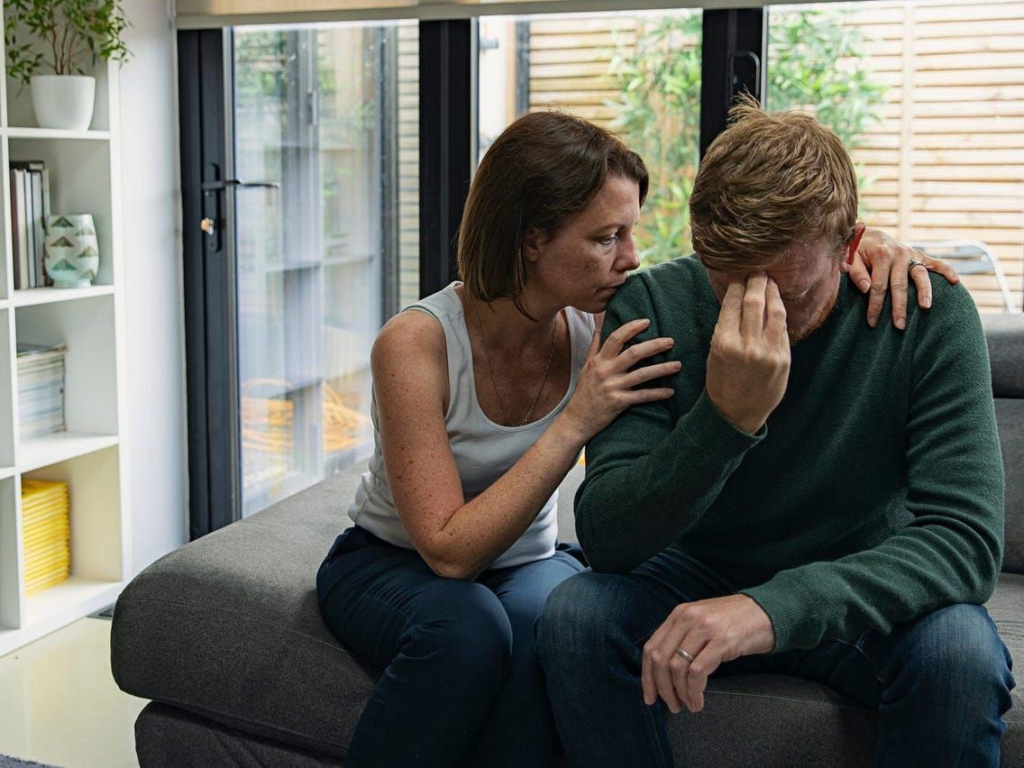 Woman comforting a man with anxiety