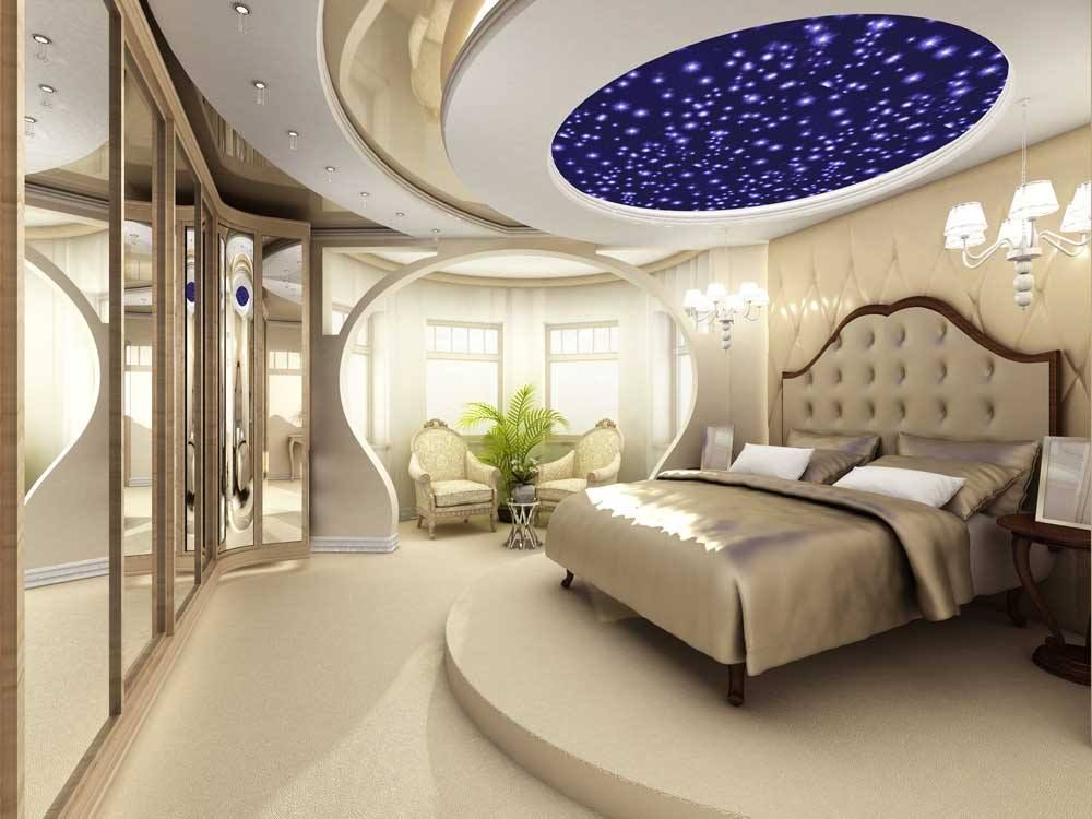 Luxurious bedroom with a tufted bed, curved walls, and a starry blue ceiling light panel