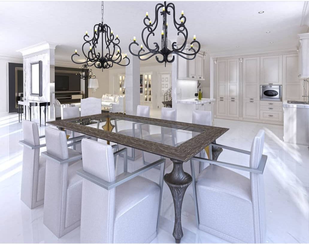 Elegant white dining room with a dark wood table, white chairs, and ornate chandeliers