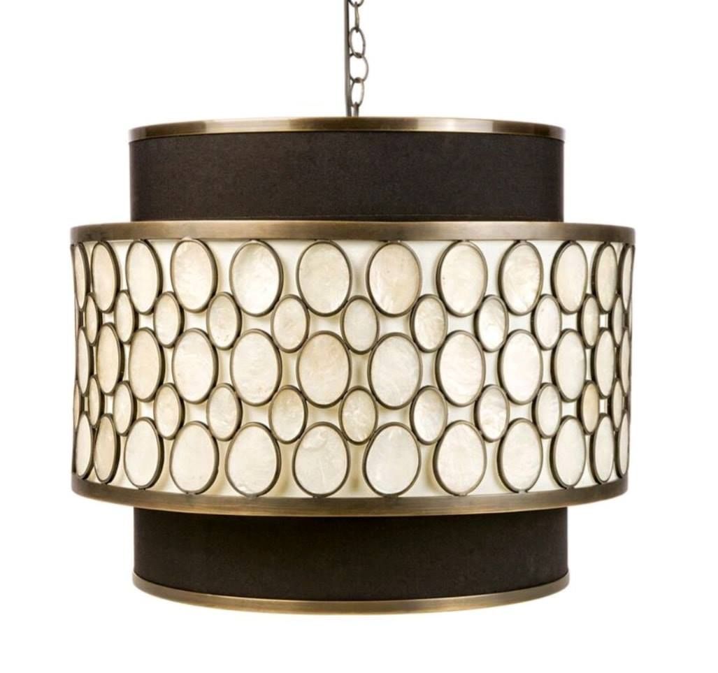 Modern drum pendant light with cream oval-patterned shade and dark brown top and bottom trim