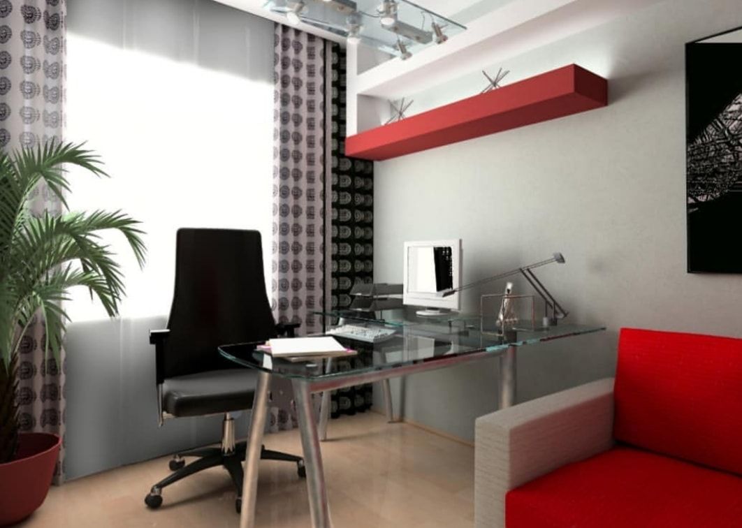 Modern home office with glass desk, black chair, red wall shelf, and red sofa by the window