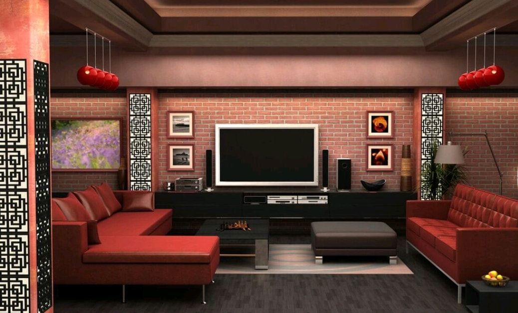 Modern living room with red sofas, dark wood paneling, and a large flat-screen TV on the wall