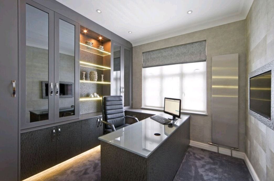 Modern office with dark furniture, glass cabinets, and a large window with blinds.