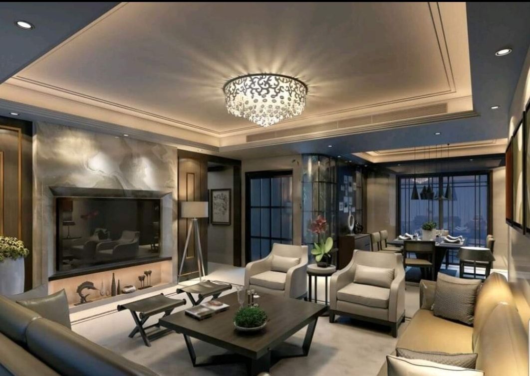 Elegant modern living room with chandelier, beige sofas, marble fireplace, and large windows