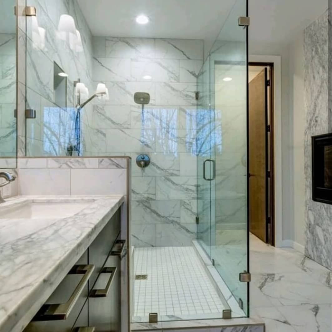 Modern marble bathroom with glass-enclosed shower and double vanity