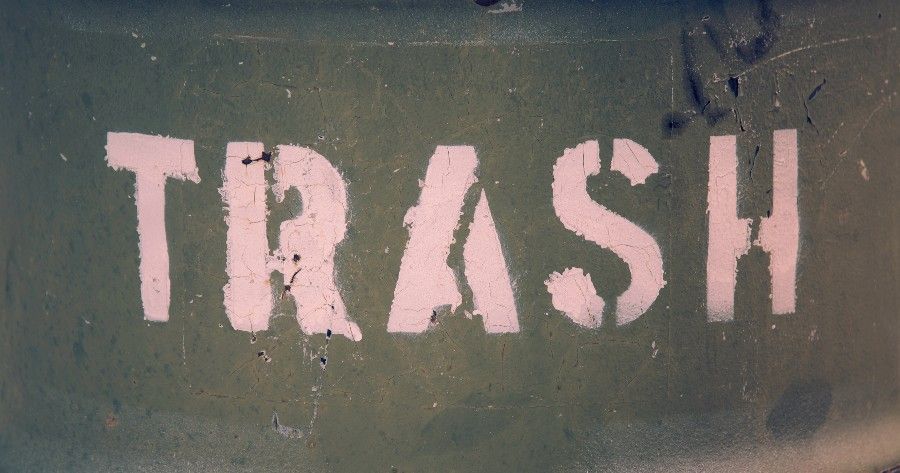 the word trash spray painted on a drum