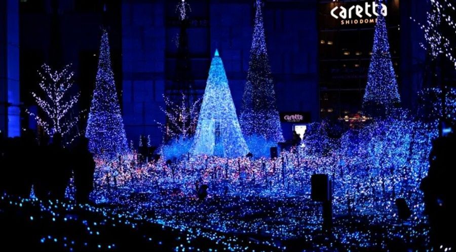 Blue Christmas light display, illuminated trees and ground, Caretta Shiodome building background.