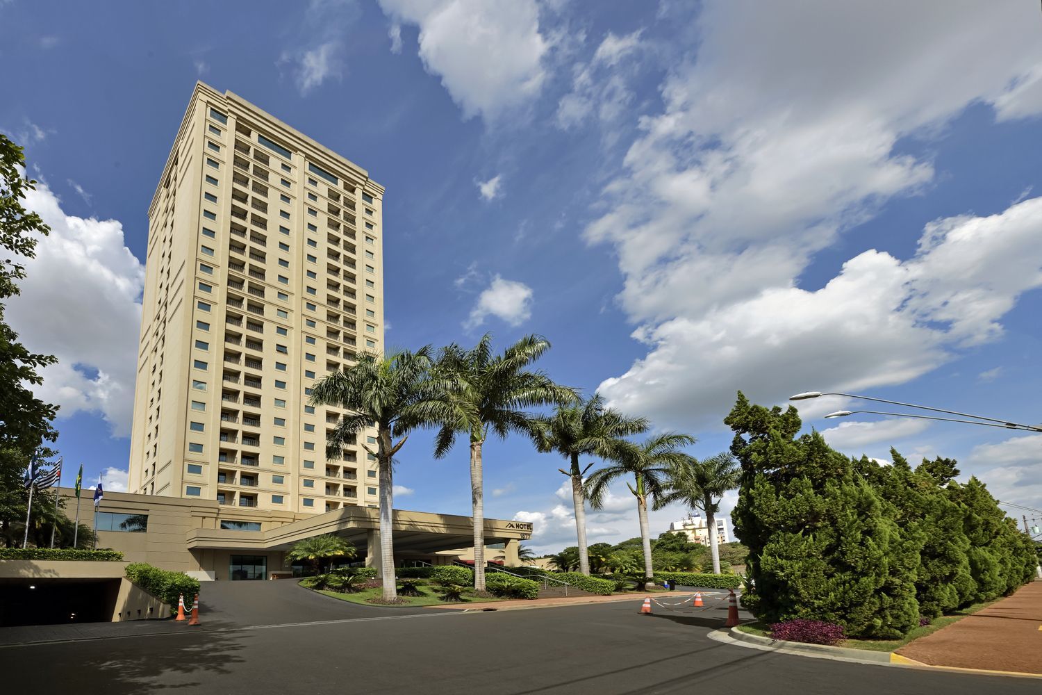 Um edifício alto com palmeiras na frente