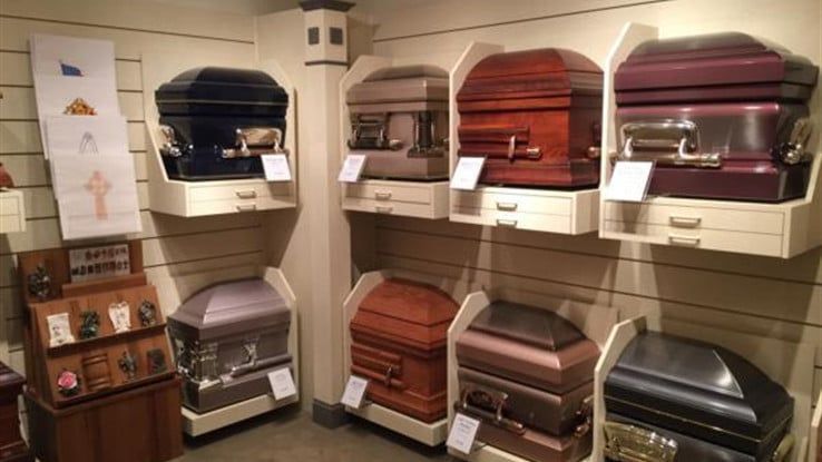 there are many different types of coffins on display in this room .
