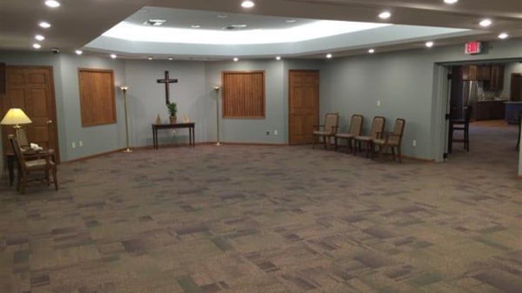 there is a cross on the wall in the middle of the room .