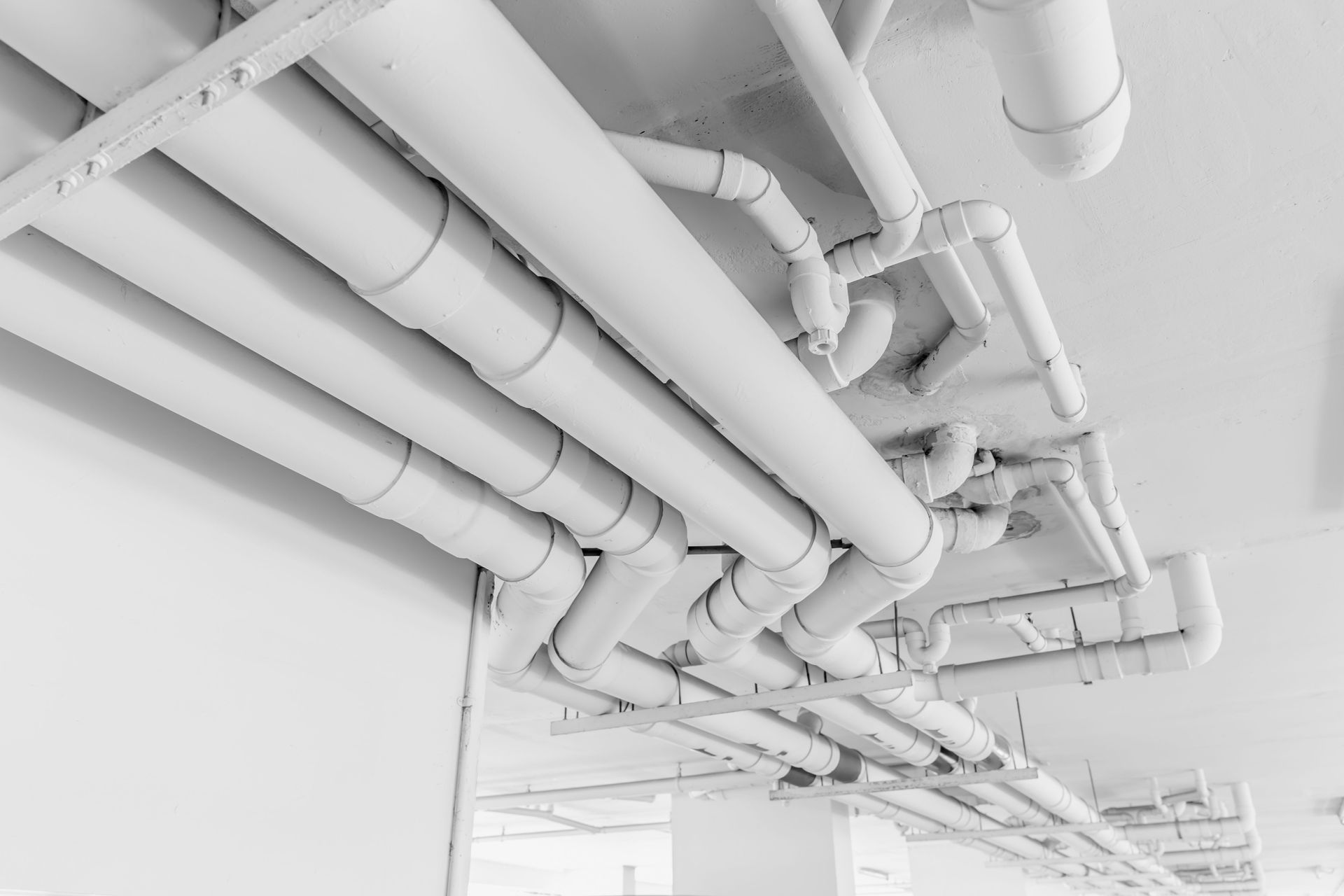 White Pipes and Fittings Run Across a Ceiling — Waves Plumbing in Central Coast, NSW