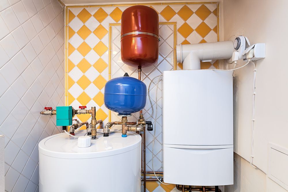 A White Water Heater, Furnace, and Expansion Tanks in a Utility Room — Waves Plumbing in Tuggerah, NSW