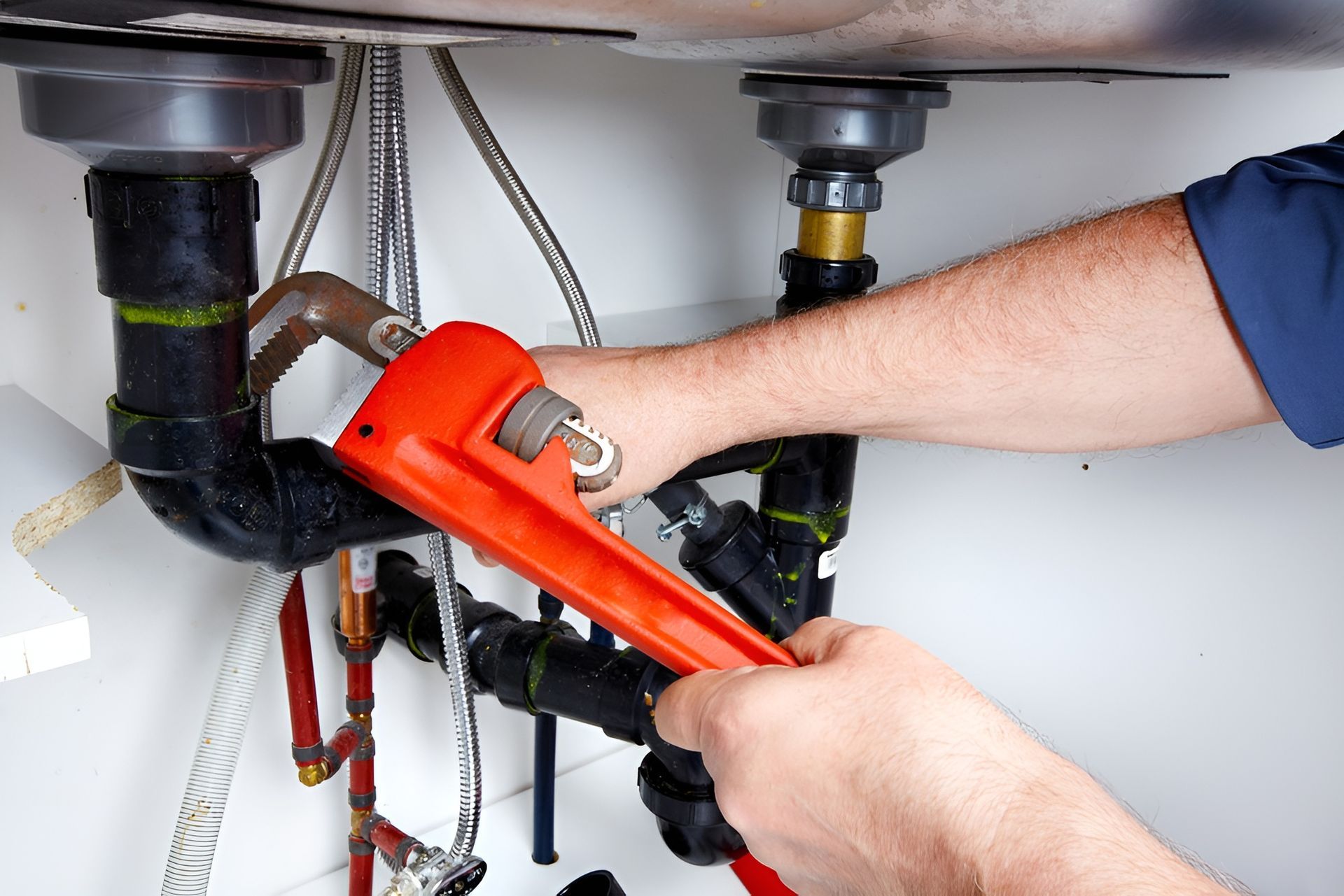 Plumber wrench to tighten black drain pipes — Waves Plumbing in Central Coast, NSW