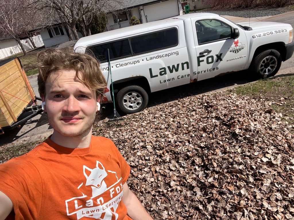 Selfie of a person in an orange shirt in front of a Lawn Fox truck. Selfie of a person in an orange shirt in front of a Lawn Fox truck.
