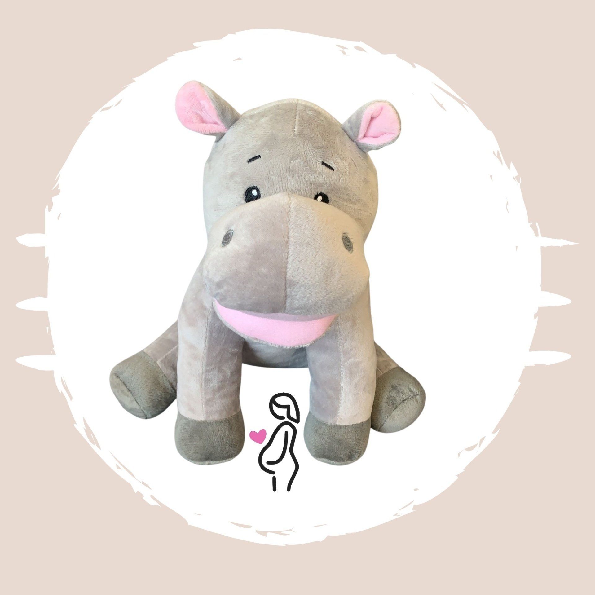 A stuffed hippo with a pink nose is sitting in a circle.