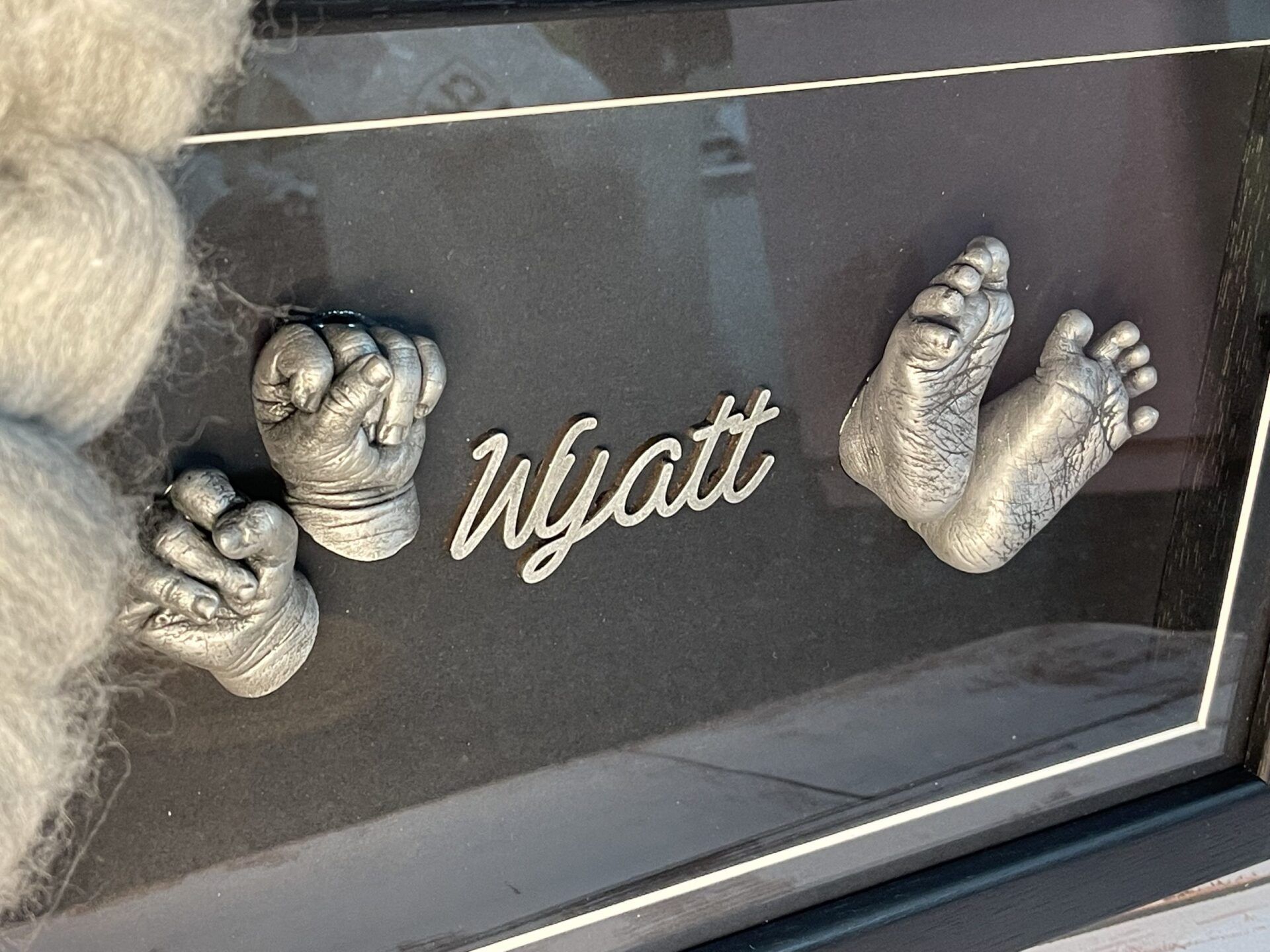 A picture of a baby 's hands and feet with the name wyatt written on it