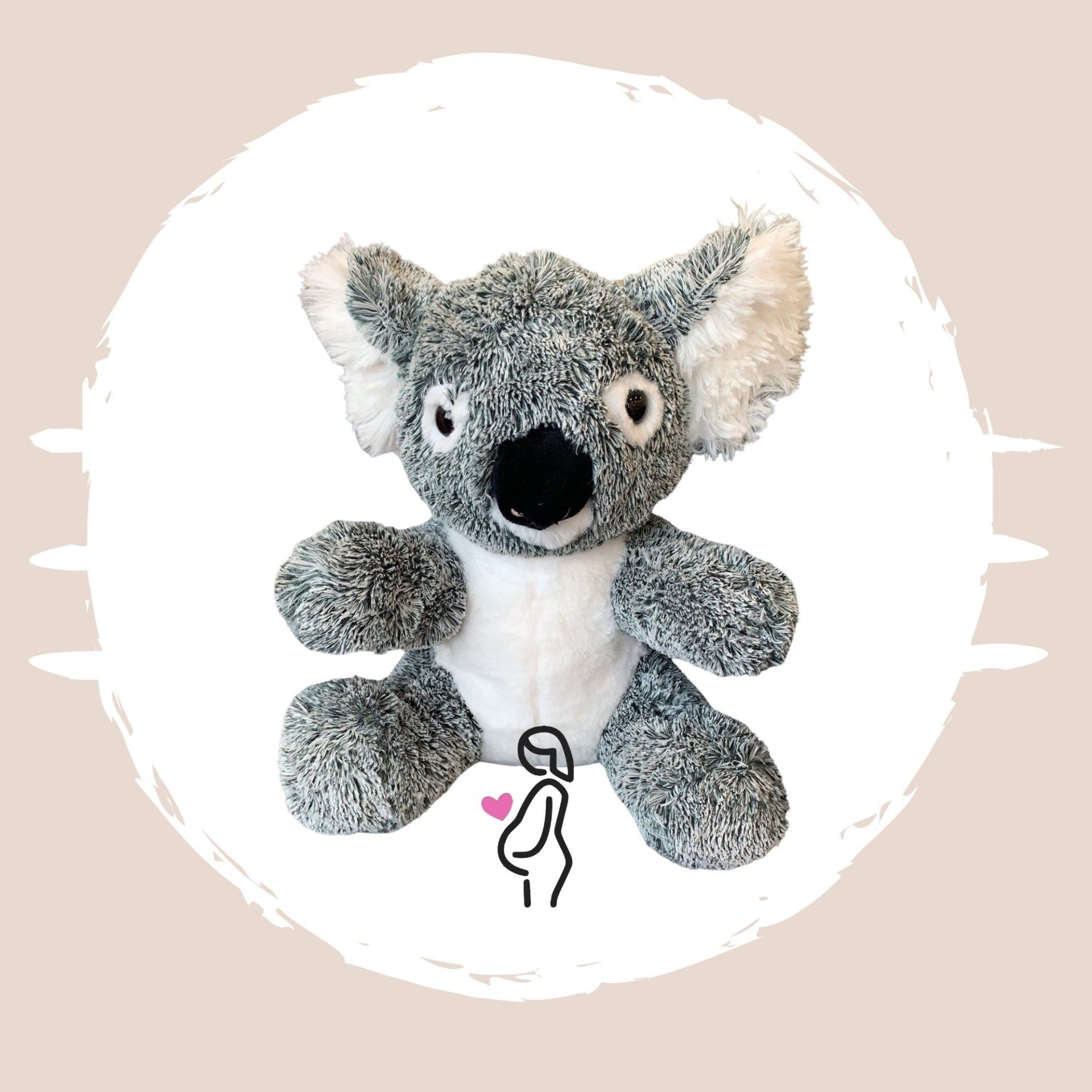 A stuffed koala bear is sitting in a white circle.