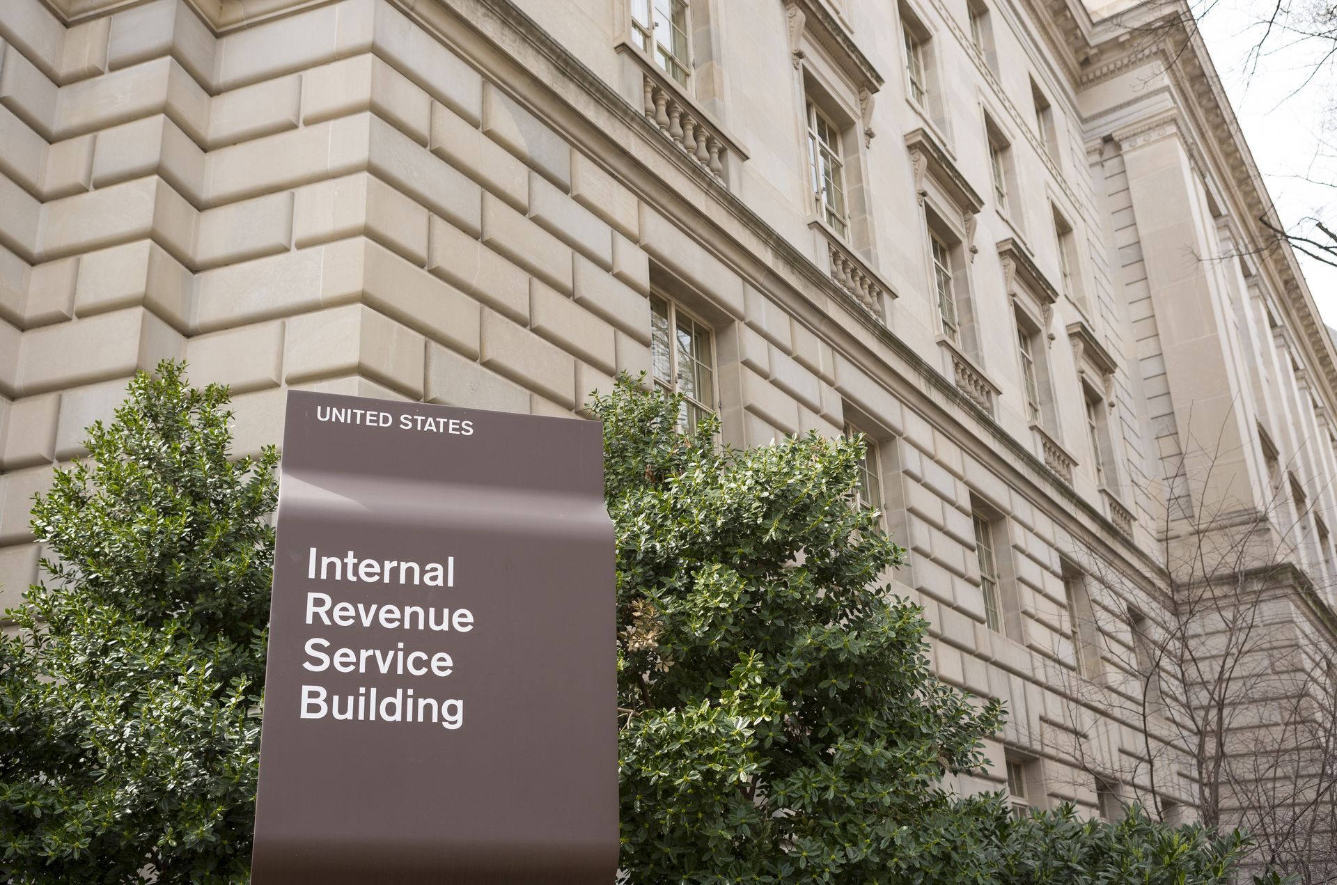Internal Revenue Service Building sign in front of a beige stone building, Washington D.C.